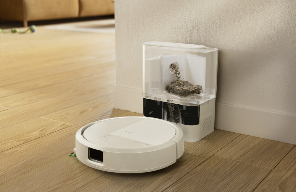 Robot sprzątający iRobot Roomba 115 Combo ze stacją opróżniającą stoi przy ścianie