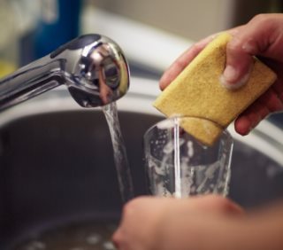 Ręczne mycie szklanek przy pomocy gąbki