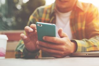 Mężczyzna trzymający w rękach smartfon