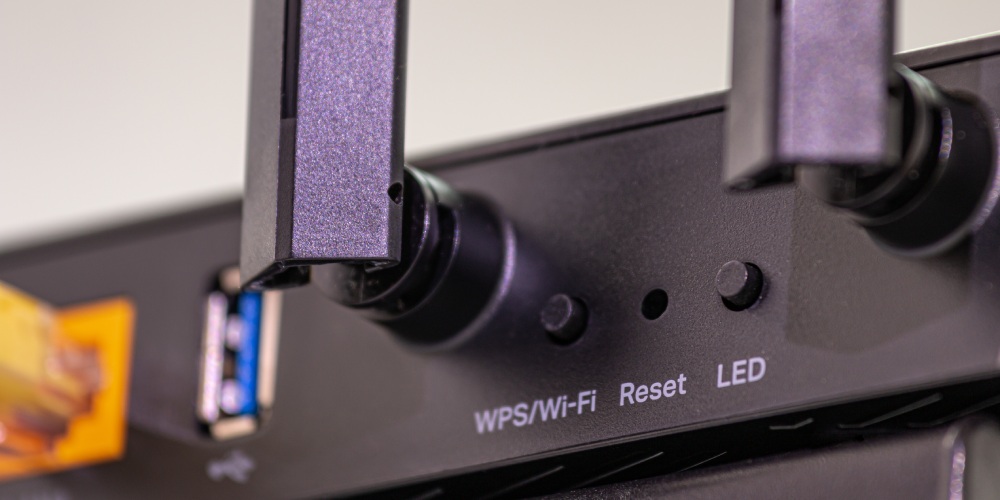 przycisk reset na obudowie routera wifi