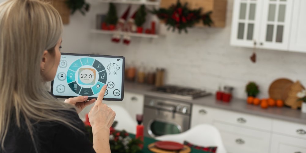 Kobieta kontroluje funkcje inteligentnego domu przy użyciu tabletu.