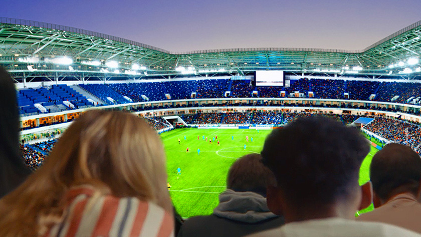 Ludzie oglądają mecz piłki nożnej z widokiem na cały stadion na dużym telewizorze