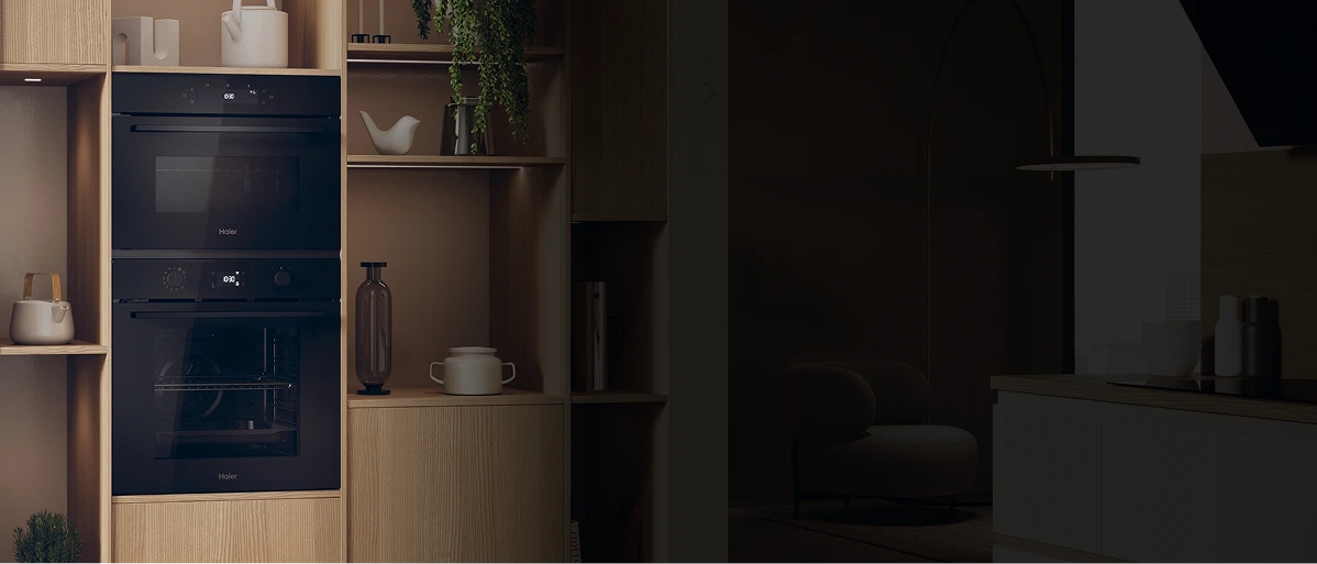 Nowoczesna kuchnia z czarnym piekarnikiem, na którym wyświetla się cyfrowy zegar. Piekarnik wkomponowany w jasne drewniane meble, z otwartymi półkami ozdobionymi wazonami, misami i roślinnością. W tle widoczna strefa wypoczynkowa z fotelem oraz współczesny blat z dekoracyjnymi przedmiotami, oświetlona ciepłym światłem.