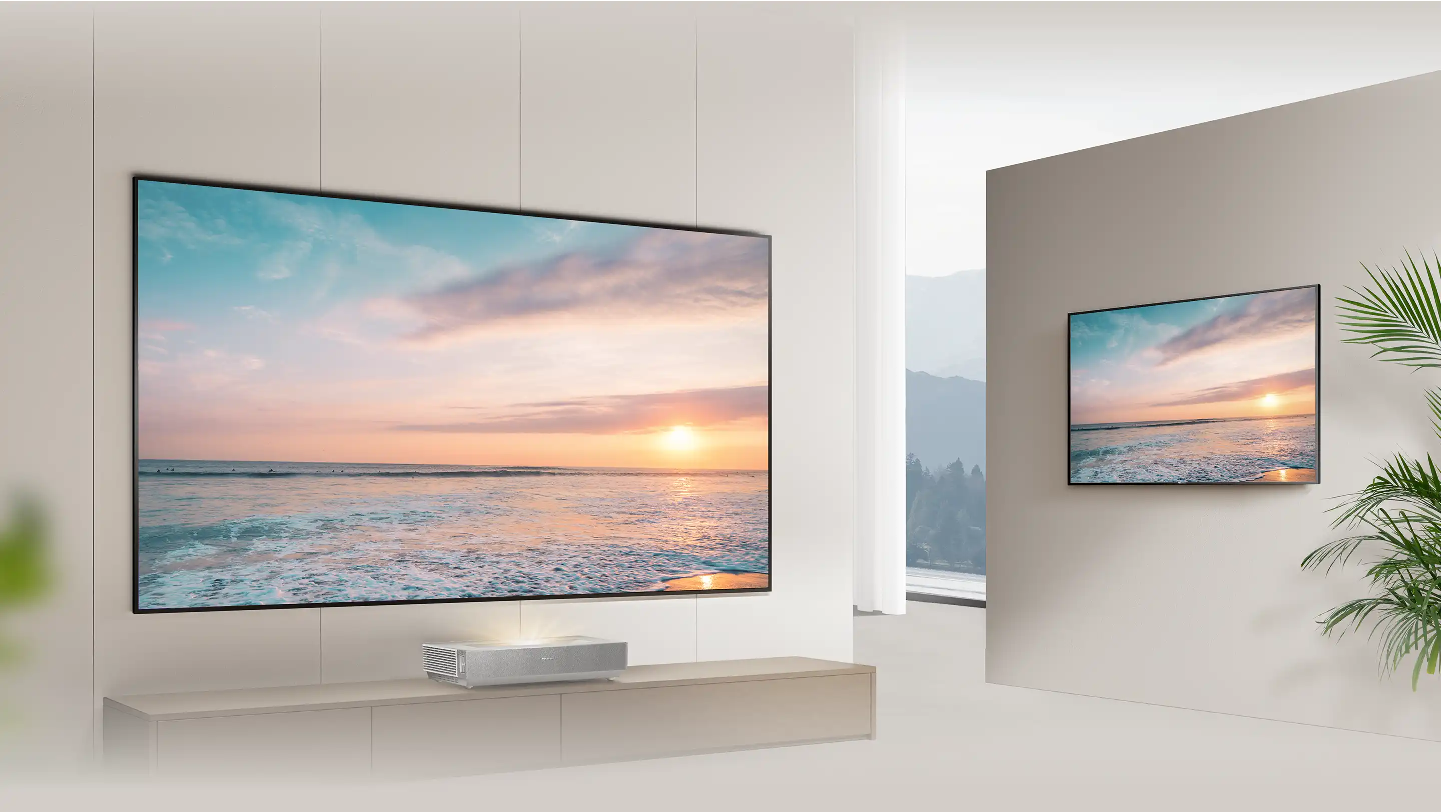 Duży telewizor z wyświetlonym zachodem słońca nad morzem, umieszczony na jasnej ścianie w nowoczesnym wnętrzu.