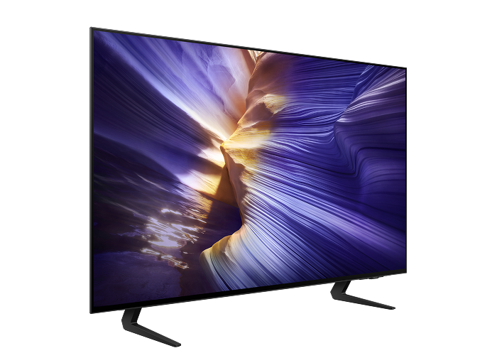 Telewizor Samsung OLED stojący pod skosem z dopiskiem Twój prezent czeka!