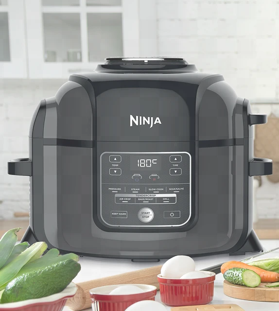 Ninja Foodi OP300EU stojący obok na blacie kuchennym w otoczeniu warzyw