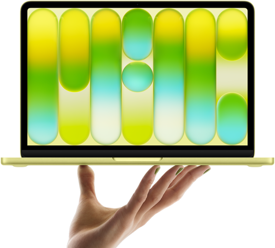 MacBook Neo w kolorze cytrusowożółtym, leżący na palcach otwartej dłoni, na ekranie widać kolorowy abstrakcyjny wzór