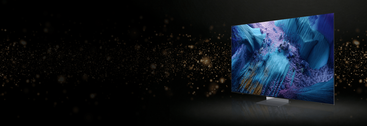 Telewizor z ekranem w niebieskich barwach pokazany z ukosa na czarnym tle ze złotym pyłem.