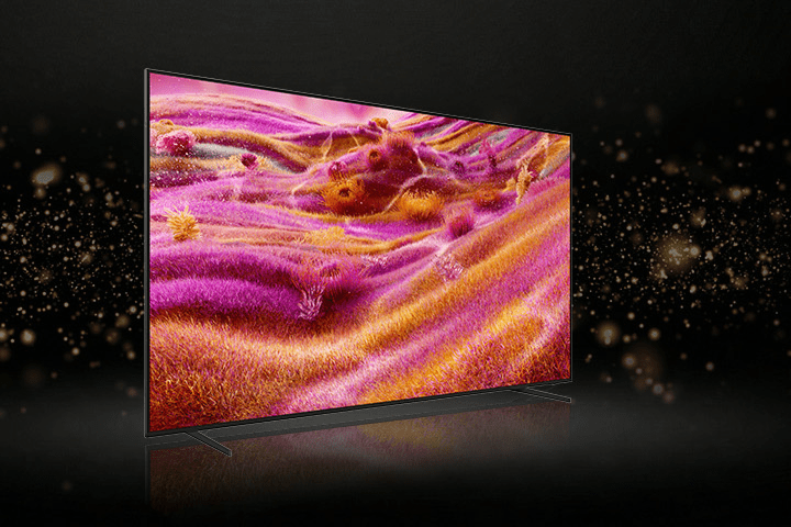 Telewizor pokazany z ukosa z ekranem w wyrazistych, różowo-pomarańczowych odcieniach.